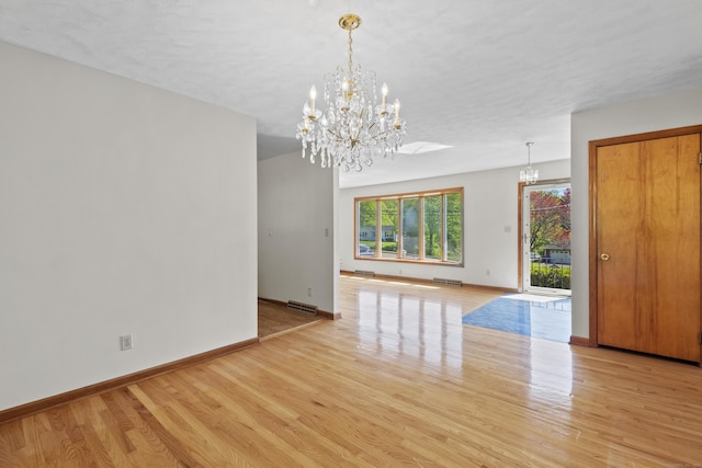 246 Sea Hill Rd, North Branford, CT 06471 - unfurnished room with a chandelier, light wood-style flooring, and baseboards