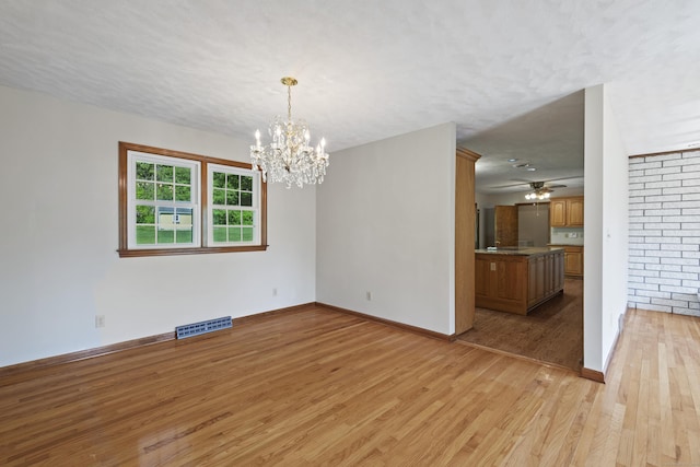 246 Sea Hill Rd, North Branford, CT 06471 - unfurnished room featuring light wood-type flooring, a chandelier, a ceiling fan, and baseboards