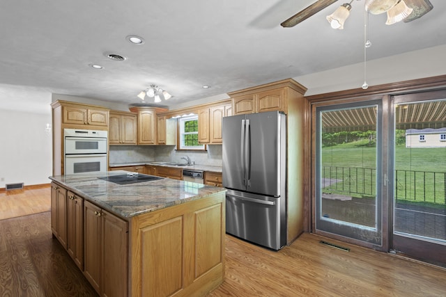 246 Sea Hill Rd, North Branford, CT 06471 - kitchen with freestanding refrigerator, white double oven, black electric stovetop, dishwasher, and a ceiling fan