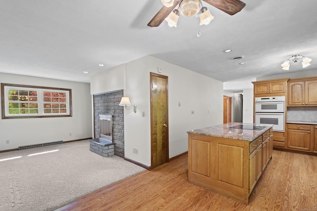246 Sea Hill Rd, North Branford, CT 06471 - kitchen with white double oven, a center island, light wood finished floors, black electric stovetop, and recessed lighting