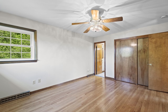 246 Sea Hill Rd, North Branford, CT 06471 - unfurnished bedroom with light wood finished floors, a closet, baseboards, a ceiling fan, and ensuite bathroom