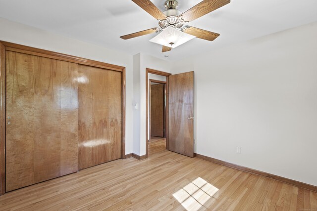 246 Sea Hill Rd, North Branford, CT 06471 - unfurnished bedroom featuring baseboards, light wood-style flooring, a closet, and a ceiling fan