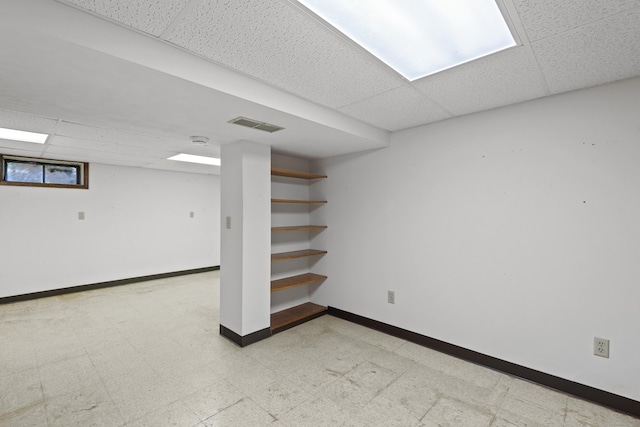246 Sea Hill Rd, North Branford, CT 06471 - basement with a drop ceiling, light flooring, and baseboards