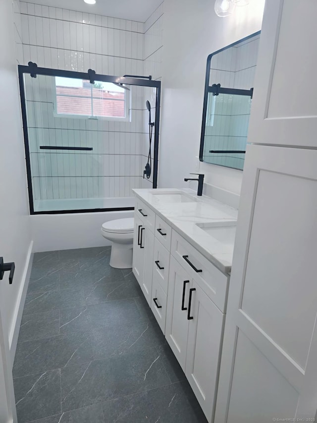 full bath with toilet, double vanity, bath / shower combo with glass door, and marble finish floors