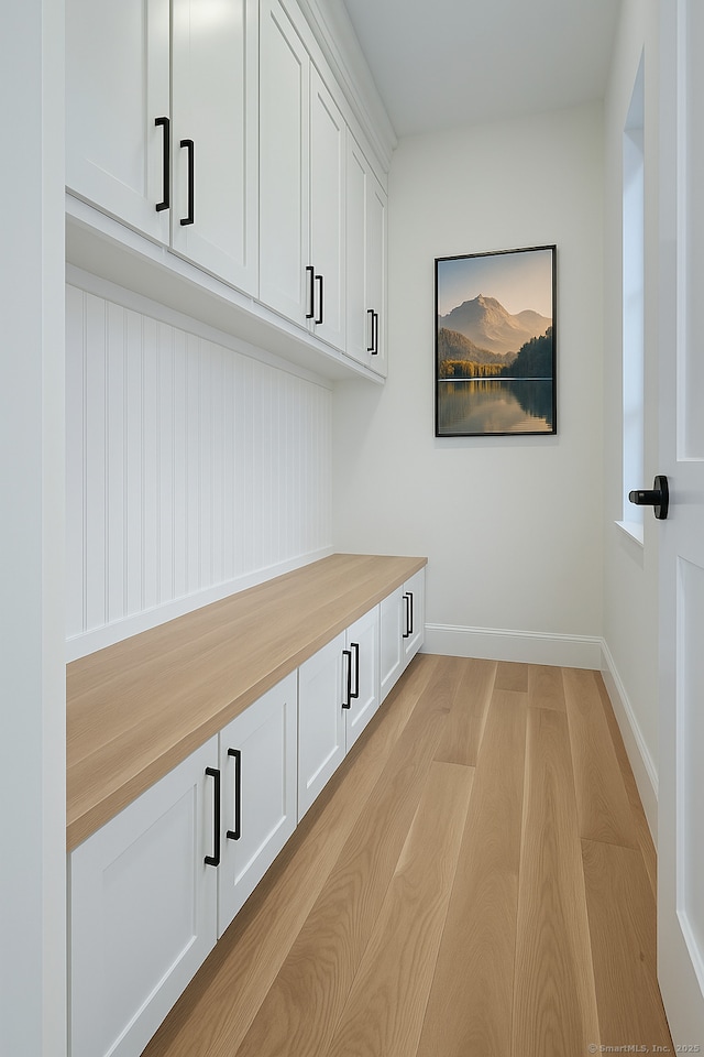 mudroom with light wood-style floors and baseboards