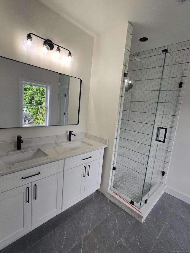 full bath featuring a stall shower, baseboards, double vanity, and marble finish floors