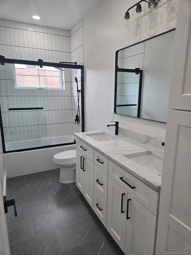 bathroom featuring marble tiled floors, toilet, double vanity, shower / bath combination with glass door, and recessed lighting