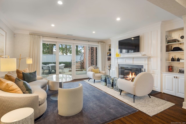 2 Mead St Unit 20, New Canaan, CT 06840 - living room featuring ornamental molding, a glass covered fireplace, built in shelves, dark wood-style flooring, and recessed lighting