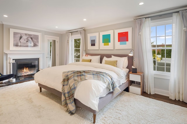 2 Mead St Unit 20, New Canaan, CT 06840 - bedroom with crown molding, access to outside, multiple windows, recessed lighting, and a fireplace with flush hearth