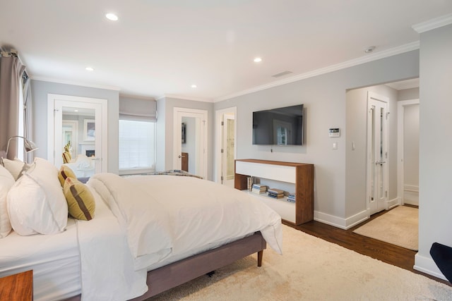 2 Mead St Unit 20, New Canaan, CT 06840 - bedroom with wood finished floors, crown molding, baseboards, recessed lighting, and ensuite bath