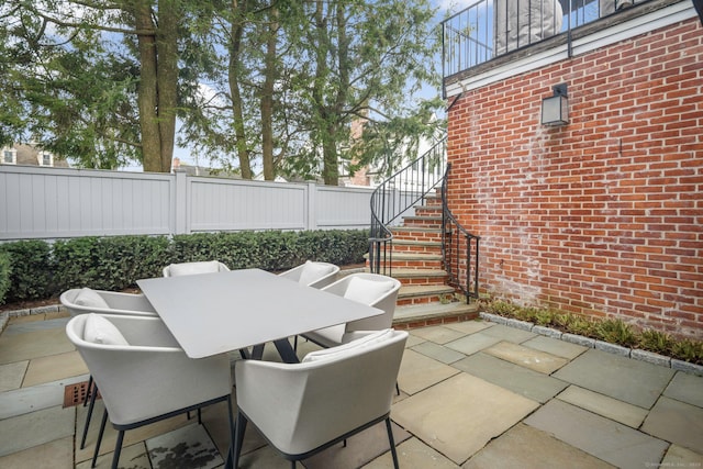 2 Mead St Unit 20, New Canaan, CT 06840 - view of patio / terrace featuring fence, stairs, and outdoor dining space