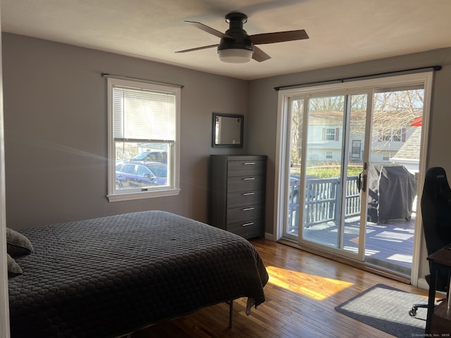 bedroom with access to outside, wood finished floors, and ceiling fan