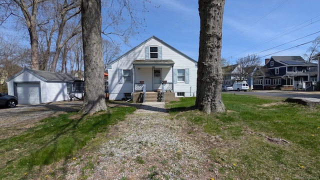 view of front of house featuring an outdoor structure, a detached garage, and a residential view