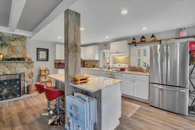 538 Winthrop Rd Unit 5, Deep River, CT 06417 - kitchen featuring freestanding refrigerator, white range with electric stovetop, white cabinets, light wood-style floors, and under cabinet range hood