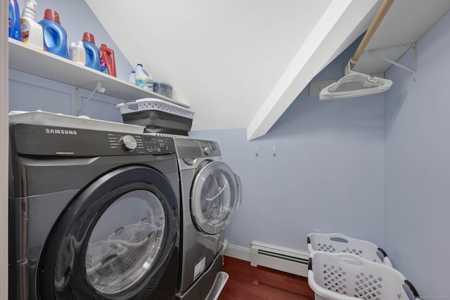 laundry room with laundry area, baseboard heating, wood finished floors, baseboards, and separate washer and dryer