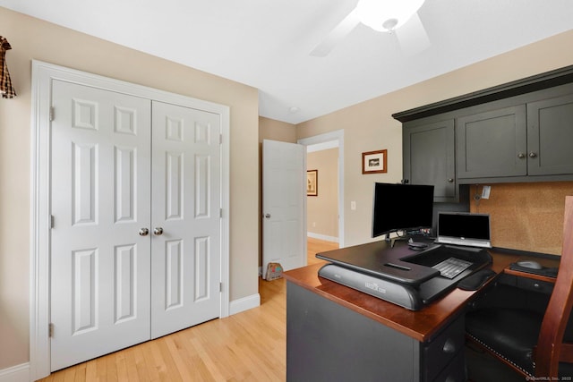 home office featuring a ceiling fan, baseboards, and light wood-style floors