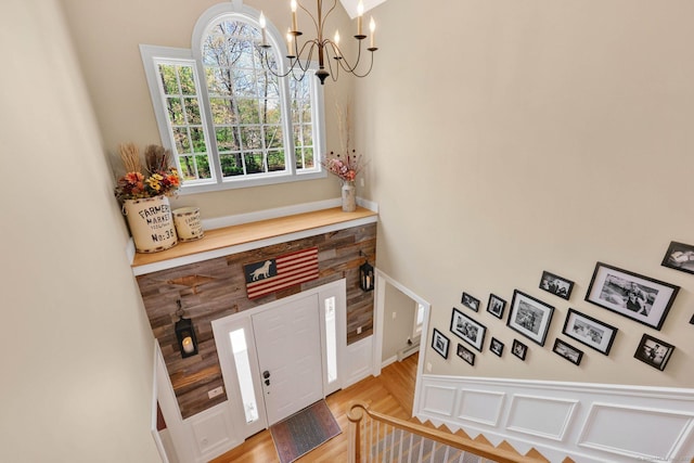 entrance foyer with an inviting chandelier and light wood finished floors