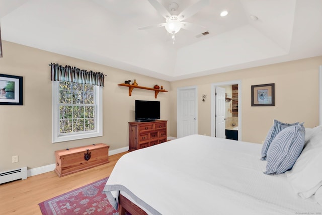 bedroom with visible vents, wood finished floors, baseboards, recessed lighting, and a baseboard heating unit