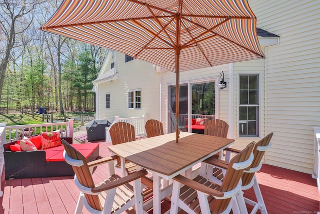 wooden terrace featuring outdoor dining area, an outdoor living space, and grilling area