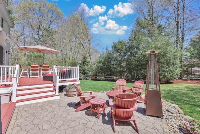 view of patio featuring a wooden deck, a fire pit, and outdoor dining space