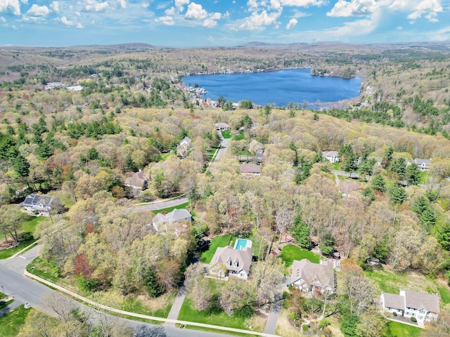 drone / aerial view featuring a view of trees and a water view