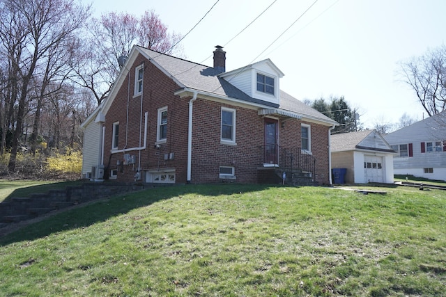 exterior space with a front lawn, brick siding, roof with shingles, and a chimney