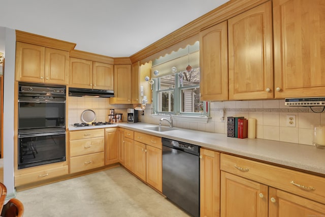 kitchen featuring a sink, light countertops, decorative backsplash, under cabinet range hood, and black appliances