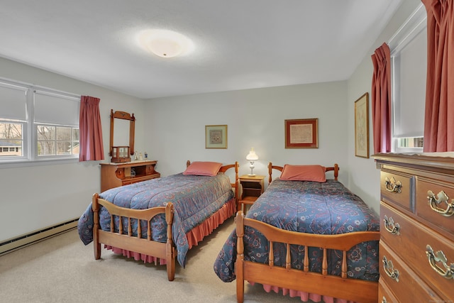carpeted bedroom featuring a baseboard heating unit