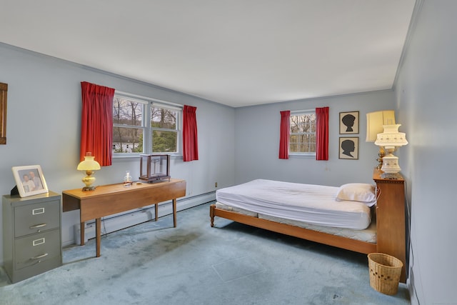 bedroom with a baseboard radiator, carpet, and multiple windows