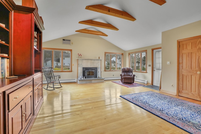 living room with a premium fireplace, a baseboard heating unit, vaulted ceiling with beams, and light wood-style flooring