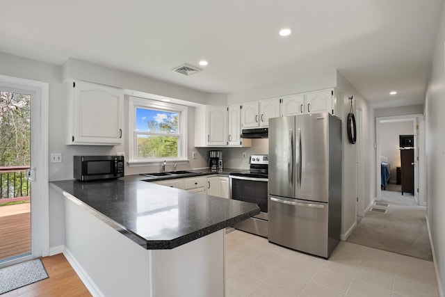 2 Goodhill Rd, New Milford, CT 06776 - kitchen with stainless steel appliances, white cabinets, dark countertops, a sink, and a peninsula