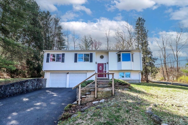 bi-level home featuring driveway and a garage