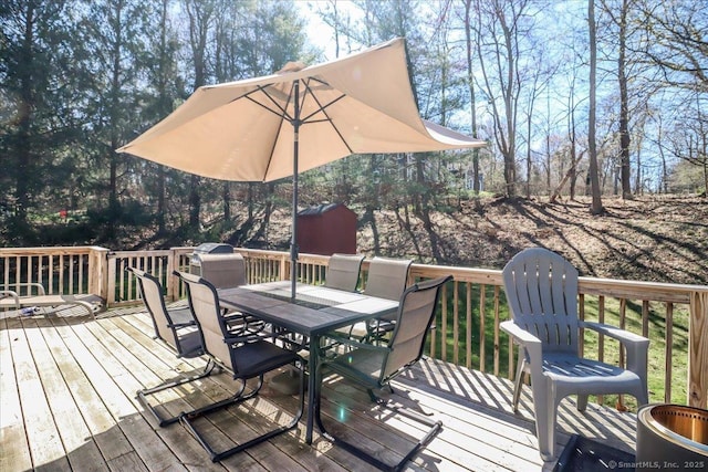 wooden terrace featuring outdoor dining space