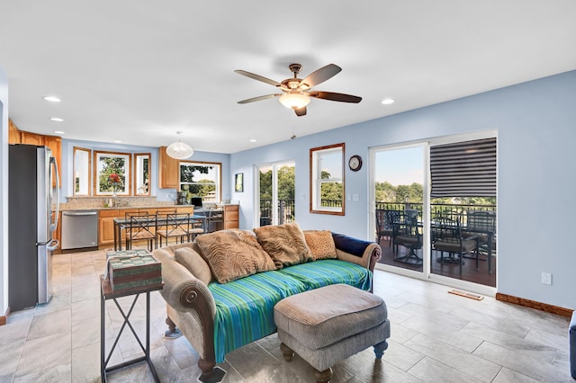 living area with visible vents, baseboards, recessed lighting, and ceiling fan