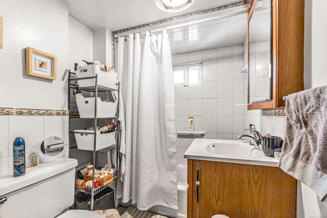 bathroom featuring tile walls, vanity, shower / bathtub combination with curtain, and toilet