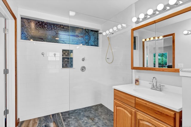 full bath featuring vanity and a walk in shower