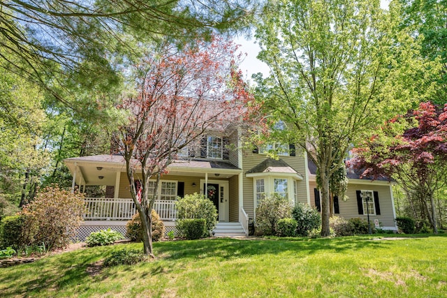 view of front of home featuring covered porch and a front yard