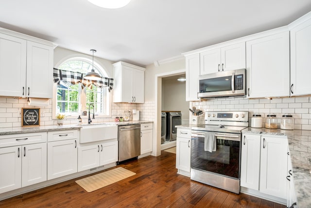 kitchen featuring appliances with stainless steel finishes, a sink, backsplash, and white cabinets