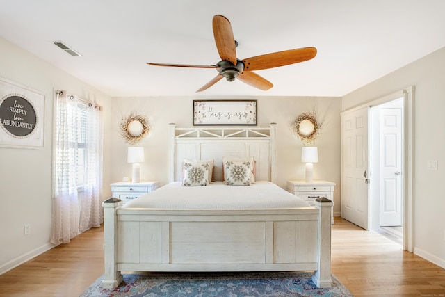 bedroom with light wood-style flooring, baseboards, and a ceiling fan