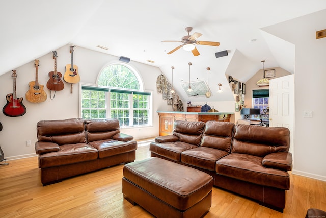 living area featuring ceiling fan, vaulted ceiling, light wood-type flooring, baseboards, and an office area