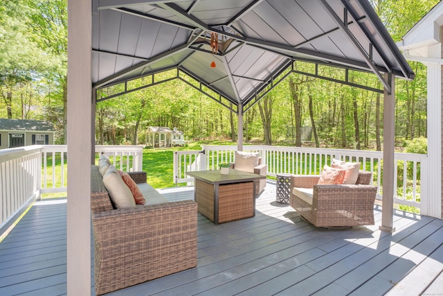 wooden terrace featuring outdoor lounge area and an outdoor structure