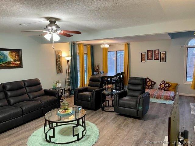 190 Main St Apt D, Manchester, CT 06042 - living room with wood finished floors, a textured ceiling, and a ceiling fan