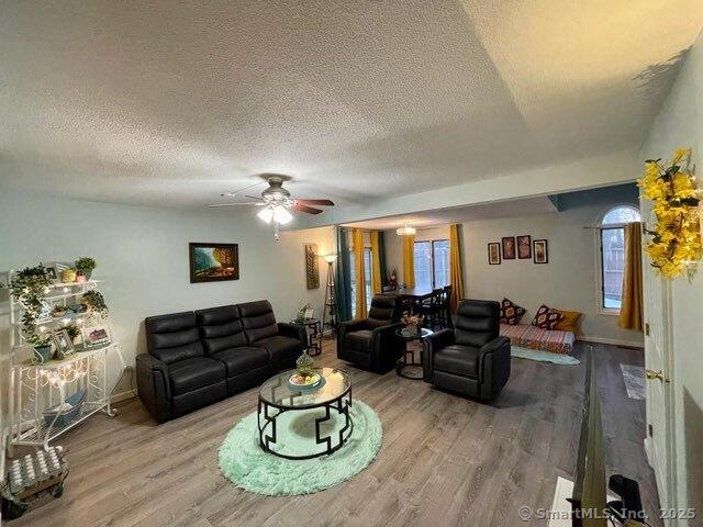 190 Main St Apt D, Manchester, CT 06042 - living room with wood finished floors, a textured ceiling, a ceiling fan, and baseboards