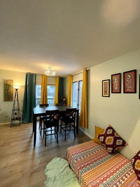 190 Main St Apt D, Manchester, CT 06042 - dining area featuring baseboards and wood finished floors