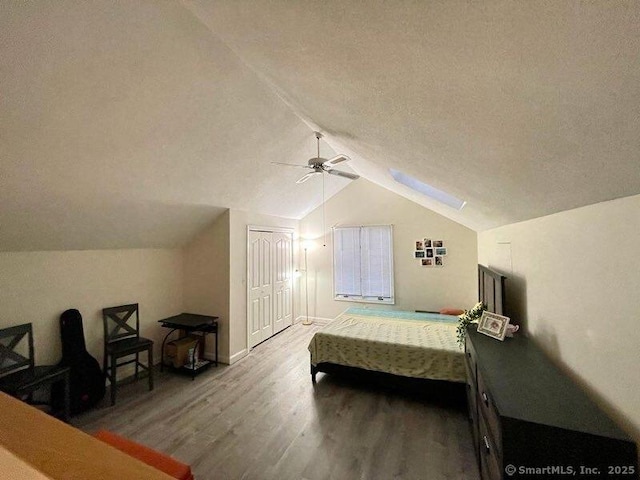 190 Main St Apt D, Manchester, CT 06042 - bedroom featuring wood finished floors, lofted ceiling, a closet, a ceiling fan, and a textured ceiling