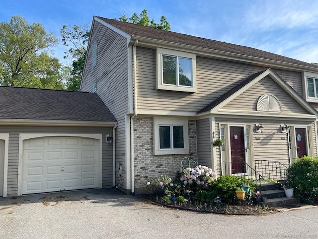 190 Main St Apt D, Manchester, CT 06042 - view of front of home featuring a garage and asphalt driveway