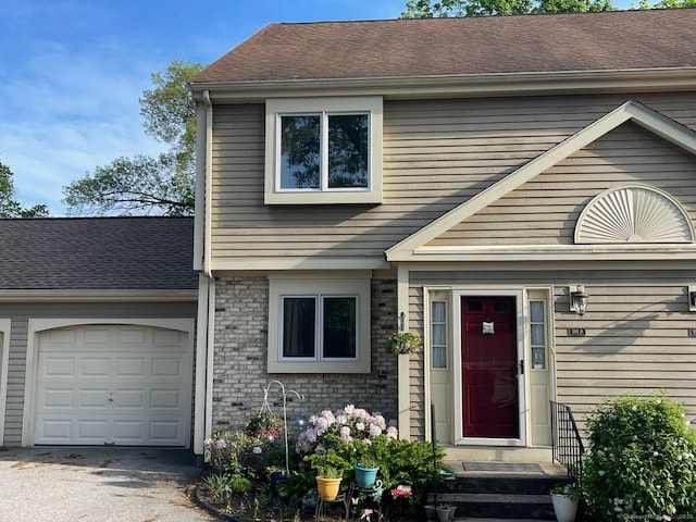 190 Main St Apt D, Manchester, CT 06042 - view of front facade with an attached garage, asphalt driveway, and brick siding