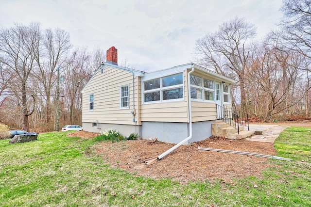 46 Sperry Dr, Guilford, CT 06437 - view of property exterior featuring a chimney and a yard
