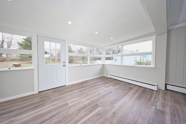 unfurnished sunroom with a baseboard radiator and plenty of natural light