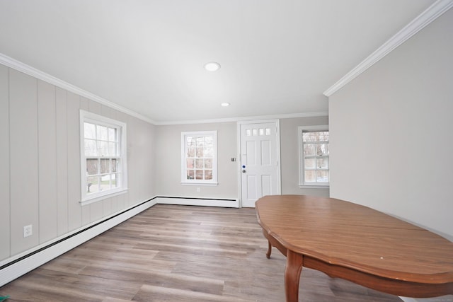 entryway featuring crown molding, a baseboard radiator, baseboard heating, recessed lighting, and wood finished floors